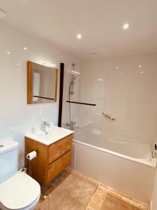 a bathroom with a toilet and a tub and a sink at Logis Nature & Mer in Saint-Josse