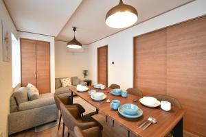 a living room with a table and a couch at Shinkoiwa 3BR house in Tokyo