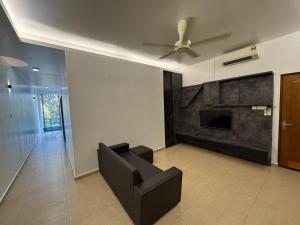 a living room with a couch and a fireplace at Pontian C Balcony in Kampong Bakek