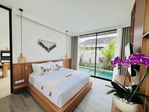 a bedroom with a large bed and a pool at Kamaimo Villa in Canggu +69 photos