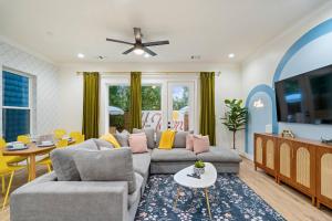 a living room with two couches and a table at The Bayou Bungalow- 5 mins to downtown, 10 to NRG, Sleeps 12, Amazing backyard! in Houston