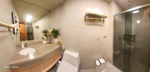a bathroom with a toilet and a sink and a shower at 1BR Condo near Tourist Spots in Baguio