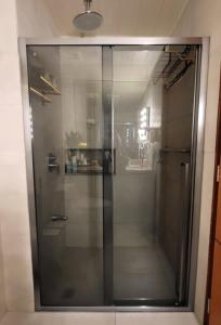 a glass shower in a bathroom with at Eya's Staycation in Baguio