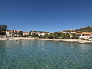 a large body of water with a beach and buildings at Apartment Banjol 137 in Rab