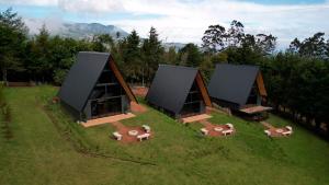 an aerial view of a house on a green field at Monteluna Fraijanes in Poasito