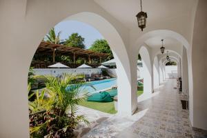 an external view of a house with a swimming pool at Nuansa Penida Hostel in Nusa Penida