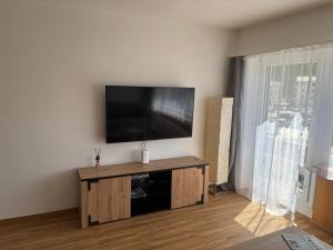 a living room with a flat screen tv on a wall at Chesa in Selva in St. Moritz