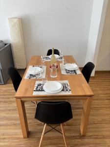 a wooden table with chairs and plates on it at Chesa in Selva in St. Moritz