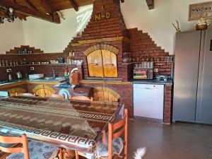 a large kitchen with a brick wall at Casa Marco in Lepşa