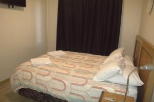 a bed with a comforter and pillows on it at Unit 66 Seafront Estate in Jurien Bay +9 photos