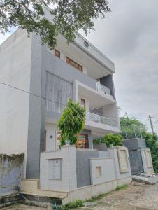 a building with a tree in front of it at Shanti vilas in Jaipur