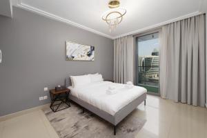 a bedroom with a bed and a large window at Stunning 1 Bedroom at Boulevard Point with Infinity Pool connected to Dubai Mall by Luxury Space in Dubai +17 photos
