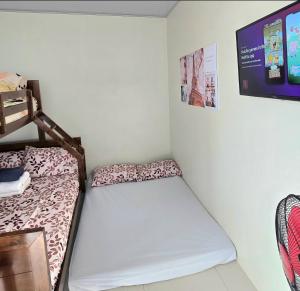 a small room with a bed and a tv at Baguio Condo Transient Grand View Unit314 by Dei Gratia in Baguio