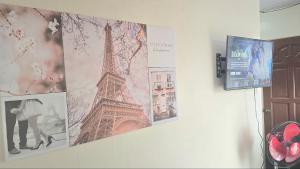 a wall with pictures of the eiffel tower on it at Baguio Condo Transient Grand View Unit314 by Dei Gratia in Baguio