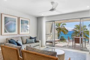 una sala de estar con un sofá y una mesa en Fairshore, en Noosa Heads