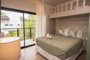 a bedroom with a large bed and a large window at Casa Pura Vida in Maragogi +75 photos