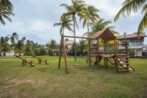 a playground in a park with palm trees at Casa Pura Vida in Maragogi