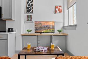 a coffee table in a kitchen with a painting on the wall at Bright and Modern Studio in Louisville # 303 in Louisville +57 photos