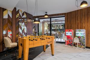 a game room with a foosball table in a store at TatryGold - Białka SPA & Resort - Apartamenty Anka Resort in Białka Tatrzanska