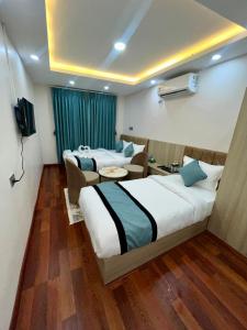 Katil atau katil-katil dalam bilik di Hotel Yuvan +3 gambar