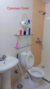 a bathroom with a toilet and a sink at AirNova 3BHK in Sonīpat +6 photos