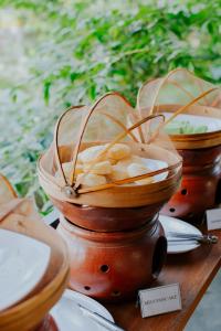 a group of wooden bowls on a wooden table at Nuansa Penida Hostel in Nusa Penida