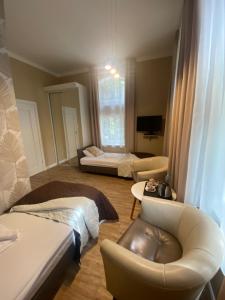 a living room with two beds and a couch at Hotel Kamil in Kwidzyn