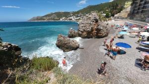 a group of people on a beach near the water at Captain's View in Dobra Voda