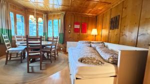 a living room with a bed and a table with chairs at Haus Berta, Montafon in Partenen +100 photos