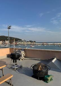 a patio with a grill and a table and a grill at Ilgwang 2Floor House in Busan