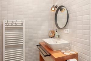 a bathroom with a sink and a mirror at Turistična kmetija Marovt in Bled +19 photos