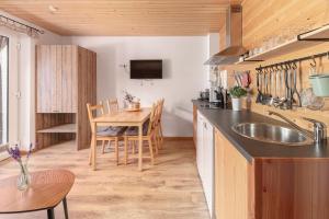 a kitchen with a sink and a table with chairs at Turistična kmetija Marovt in Bled