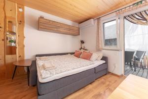 a small bedroom with a bed and a table at Turistična kmetija Marovt in Bled