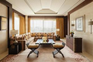 a living room with a couch and a table at Raffles Dubai in Dubai