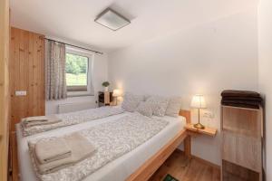 a large bed in a room with a window at Turistična kmetija Marovt in Bled