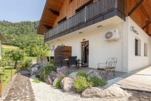 a patio of a house with a table and chairs at Turistična kmetija Marovt in Bled