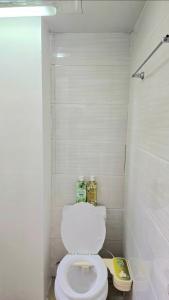 a bathroom with a white toilet in a room at Zone Vill Baguio Condo Transient Unit 505 by Dei Gratia in Baguio
