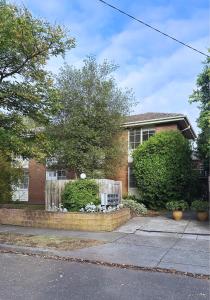 een stenen huis met een hek ervoor bij Chic Malvern Retreat, Ideal for Study, Relaxation, Fun in Melbourne +17 foto's