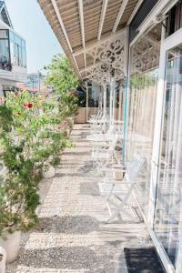 a row of white chairs sitting on a patio at TTG Hostel In Da Lat in Da Lat