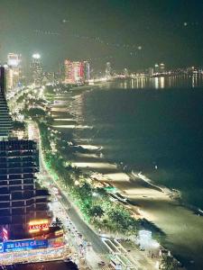 a view of a beach at night with a city at My Khe Beach-My An Son Tra Da Nang-ANV APT in Da Nang