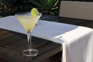 a margarita with a lime in a glass on a table at Abangane Guest Lodge in Hazyview