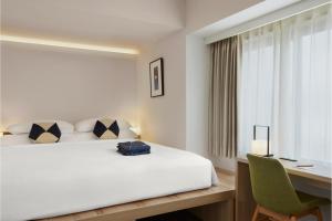 a hotel room with a bed and a desk and a computer at ASAI Kyoto Shijo in Kyoto