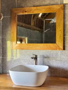 a white sink in a bathroom with a mirror at Jumanji B&B in Kinyasini
