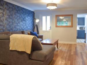 a living room with a couch and a table at Castle Street Cottage in Narberth