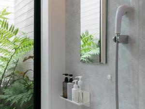 ein Badezimmer mit Dusche, Seife und Shampoo in der Unterkunft Koahome in Miyako-jima