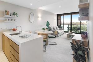 a kitchen and living room with a couch and a table at 108 Flinders - Stunning Views & Prime Location in Melbourne