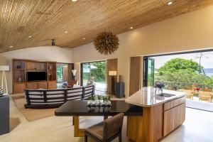 an open kitchen and living room with a table and chairs at Andaz Peninsula Papagayo Resort, Costa Rica, by Hyatt in Papagayo, Guanacaste