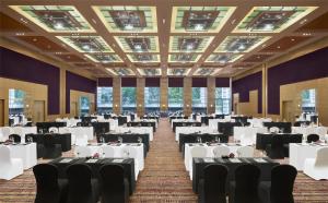 a banquet hall with white tables and chairs at Grand Hyatt Mumbai Hotel and Residences in Mumbai