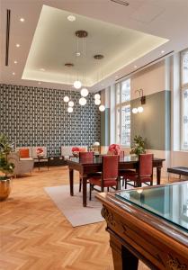 a dining room with tables and chairs in a room at DoubleTree By Hilton Trieste in Trieste