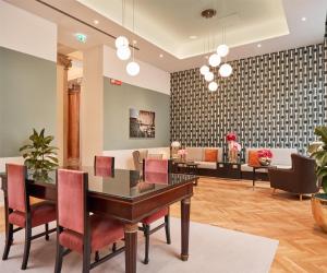 a living room with a table and chairs at DoubleTree By Hilton Trieste in Trieste